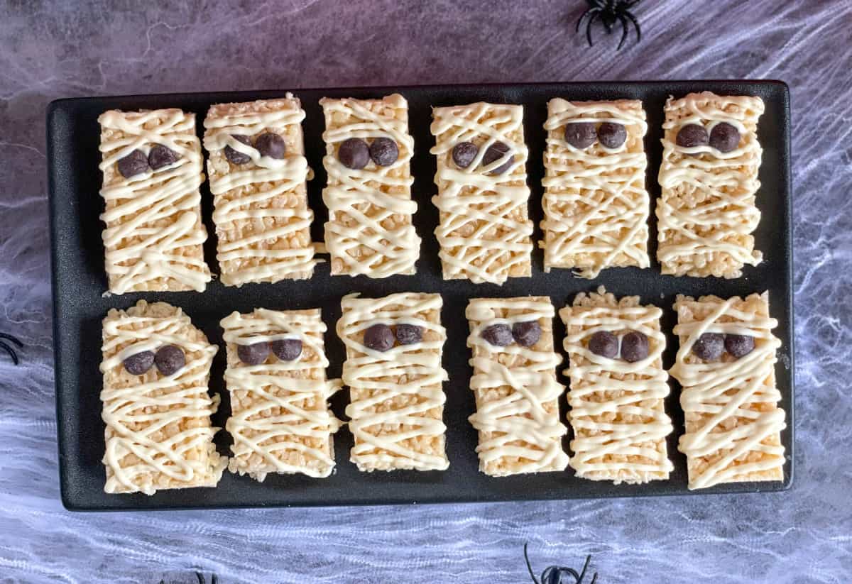 Halloween Mummy Rice Bubble Krispie Treats on a black plate