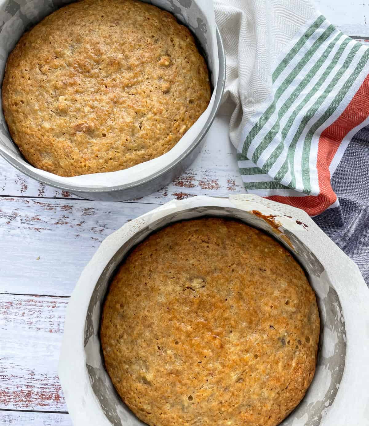 Freshly baked golden brown hummingbird cakes in lined cake tins