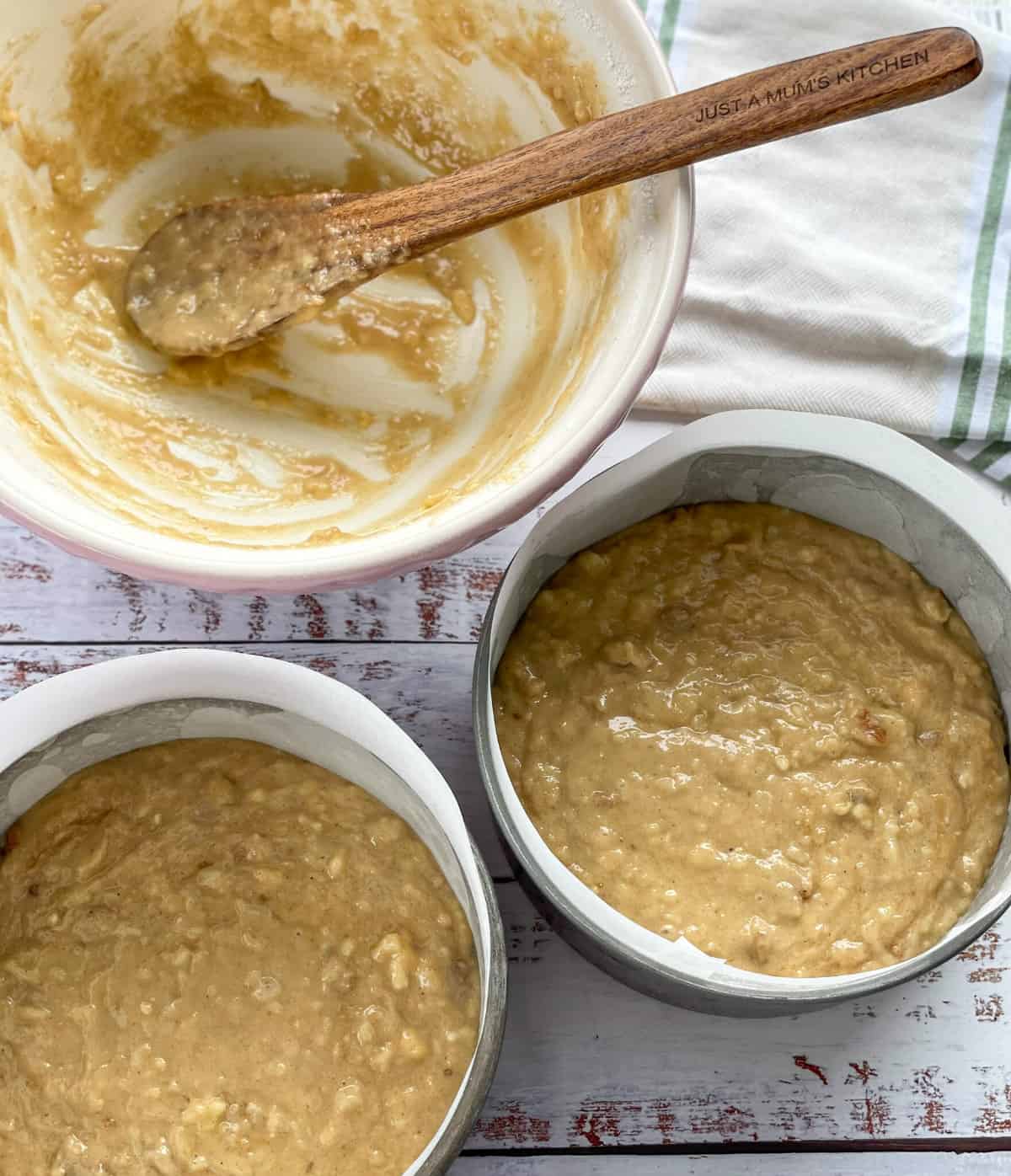 Evenly filled baking pans with hummingbird cake batter, ready to bake 