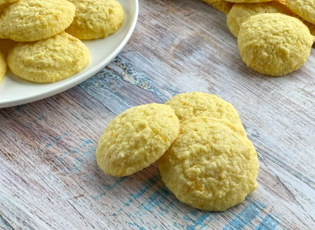A pile of lemon and coconut biscuits on a wooden background 