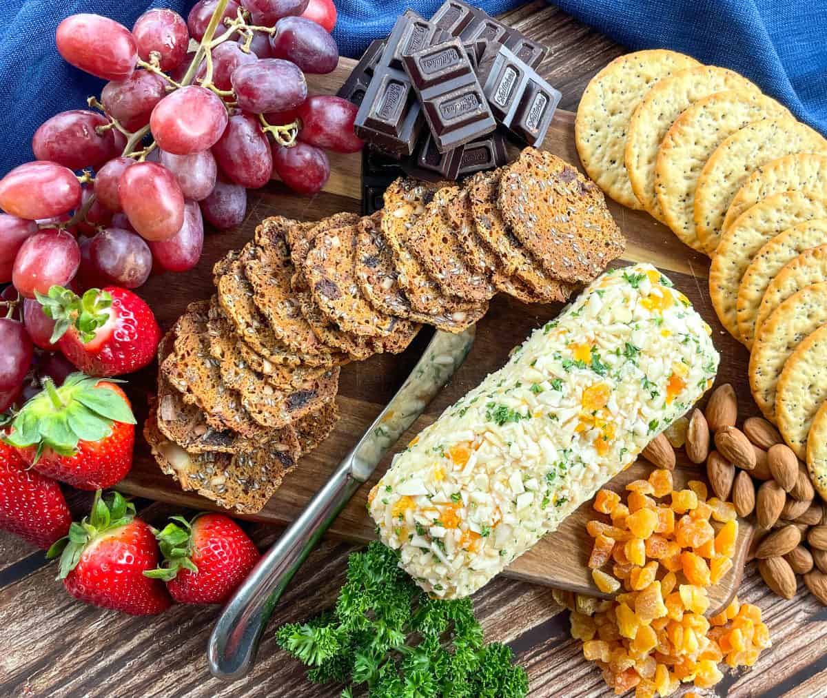 Homemade Cheese Log on a cheese platter with fruit 