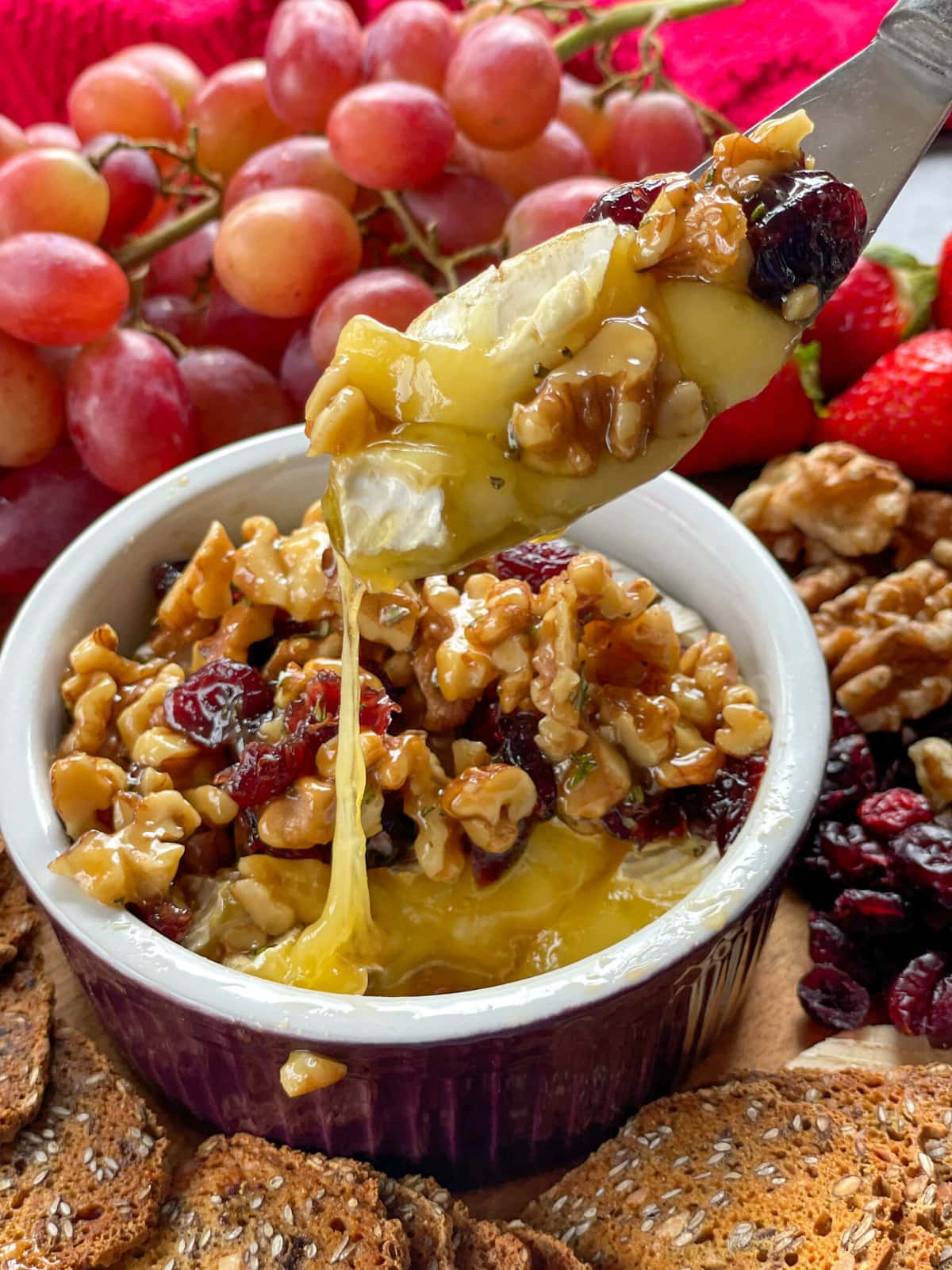 Hot baked camembert with a crunchy walnut honey rosemary cranberry topping