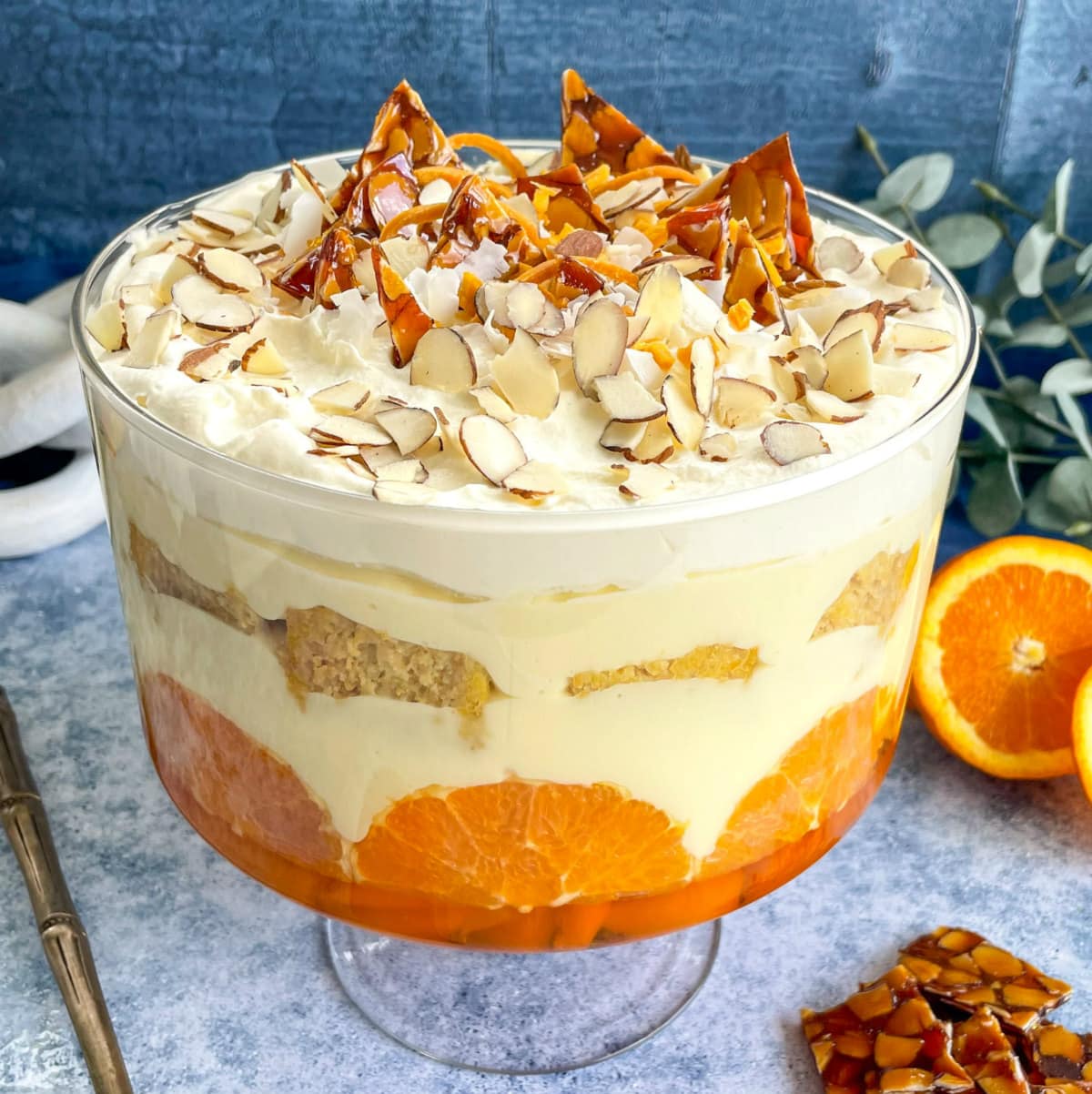 Orange Trifle with toppings of almond brittle, coconut, almonds and dried mango
