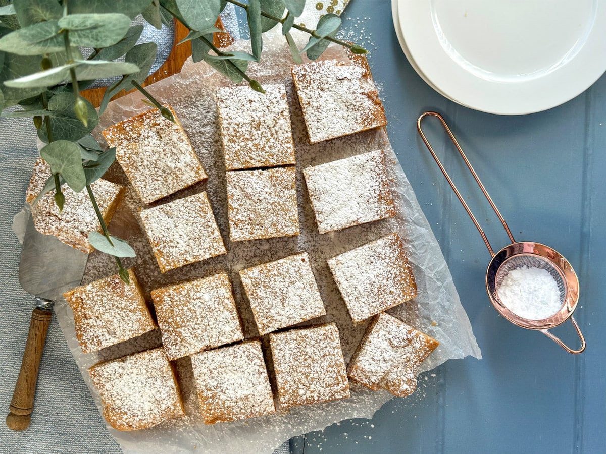 Slices of blondie dusted in icing sugar 