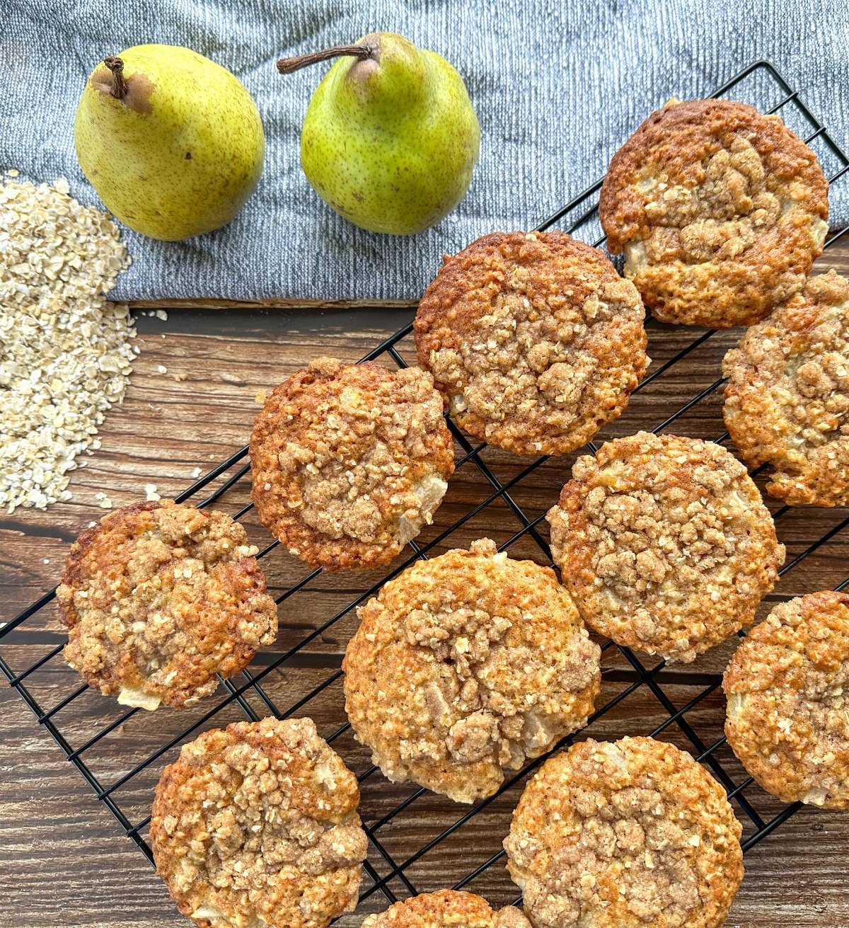 Pear and Oatmeal muffins with a brown sugar streusel on a black wire rack 