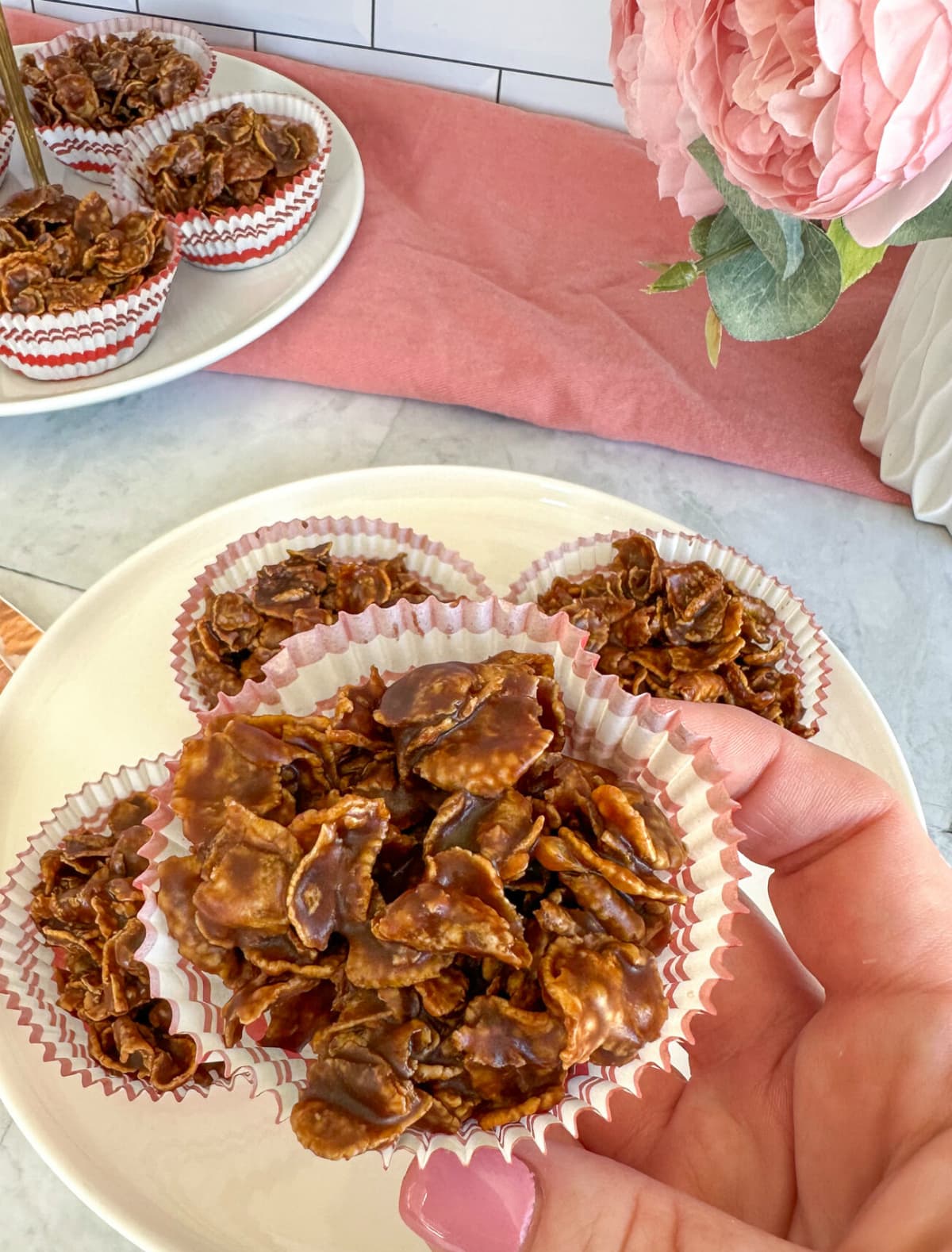 Hand holding chocolate cornflake crunchies 