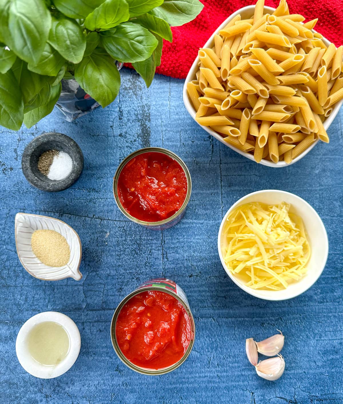 Ingredients used to make tomato and basil penne pasta, see the recipe card for full details 