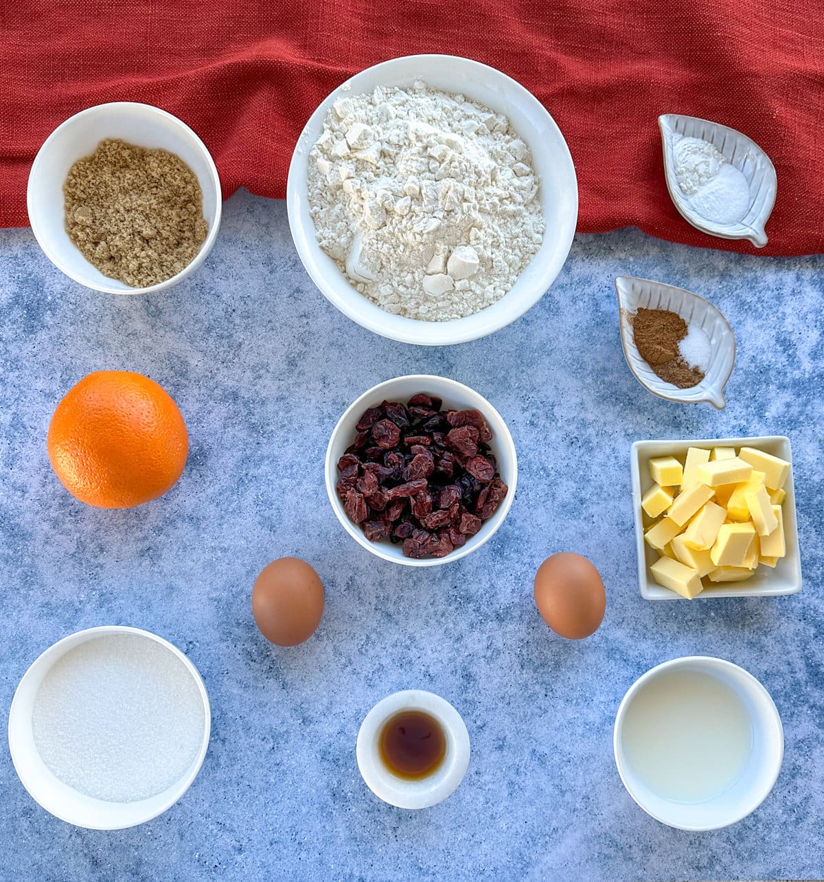 Ingredients required to make orange and cranberry muffins, see recipe card for full details