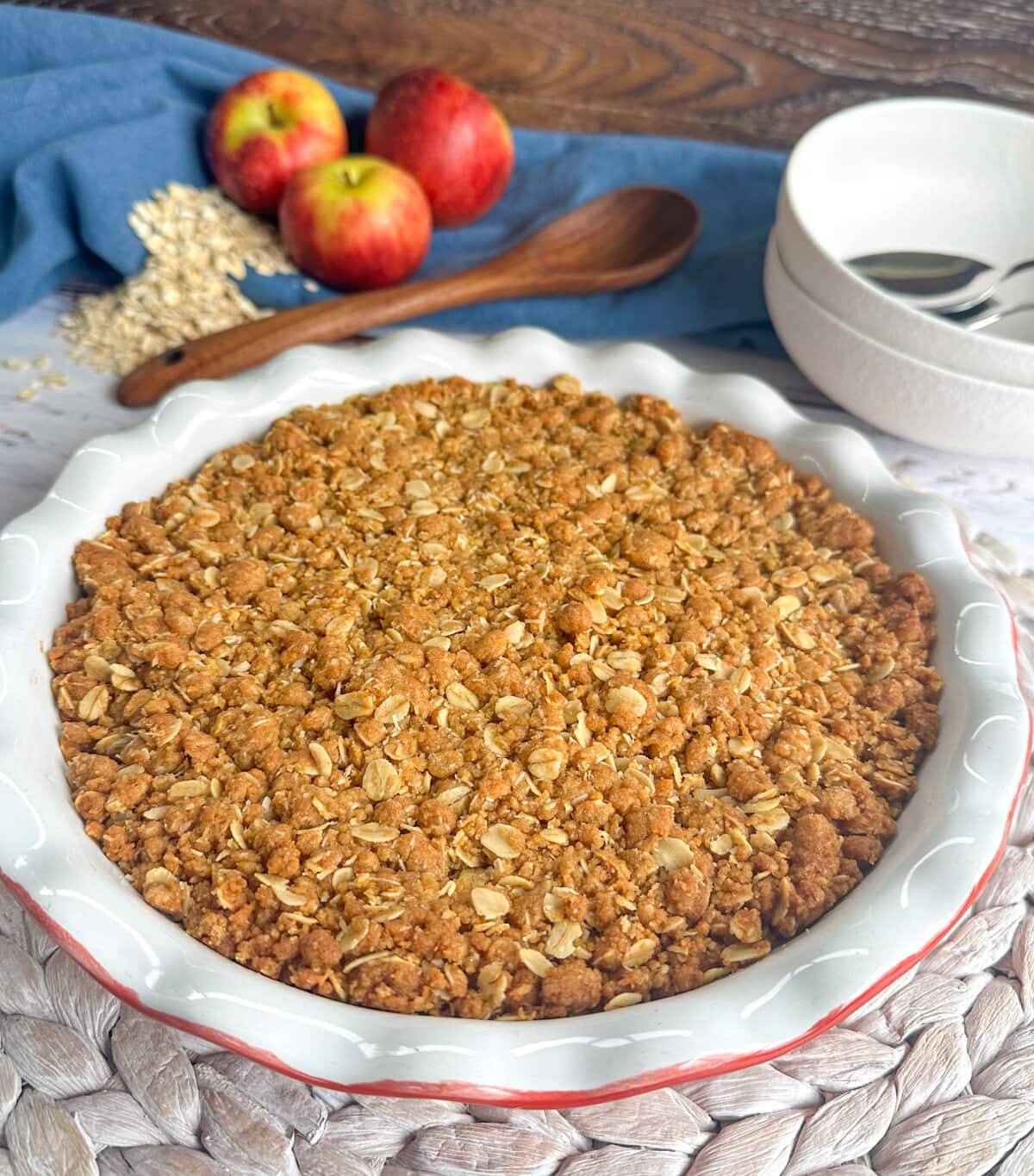 Anzac Apple Crumble, golden brown fresh from the oven in a red and white pie dish