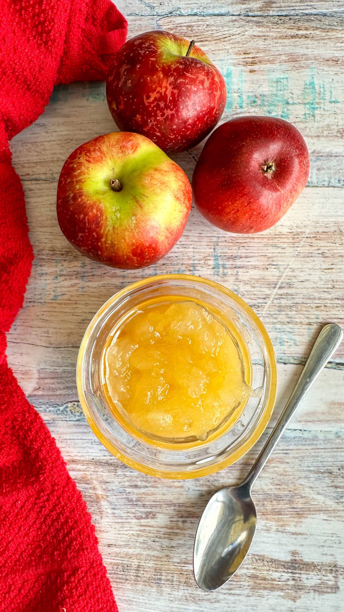 apple compote in a glass jar with fresh apples