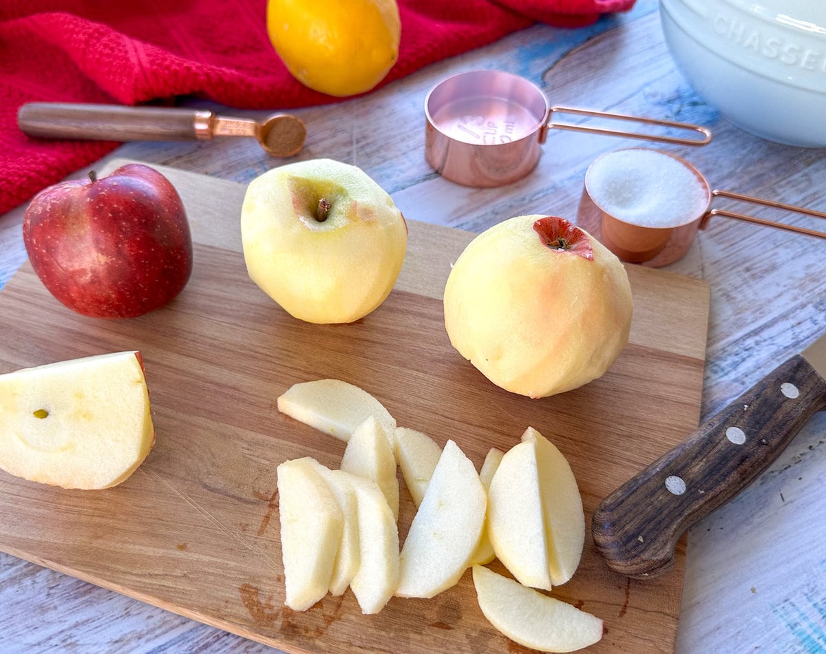 wooden chopping board with peeling apples ready to make stewed fruit