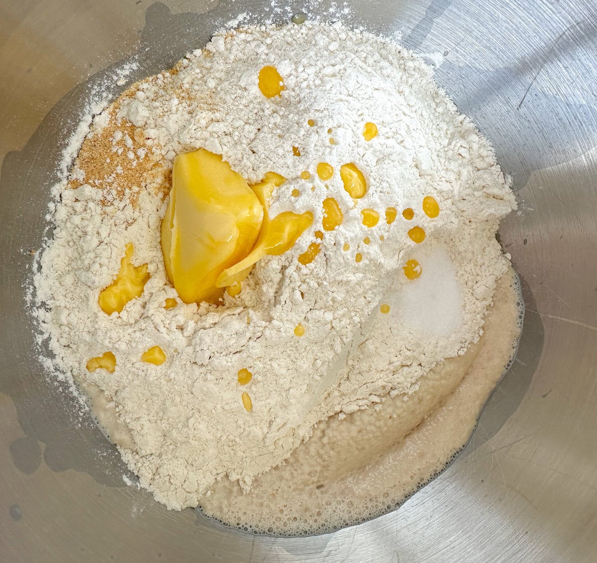 Bloomed yeast with added flour and butter in a stand mixer bowl