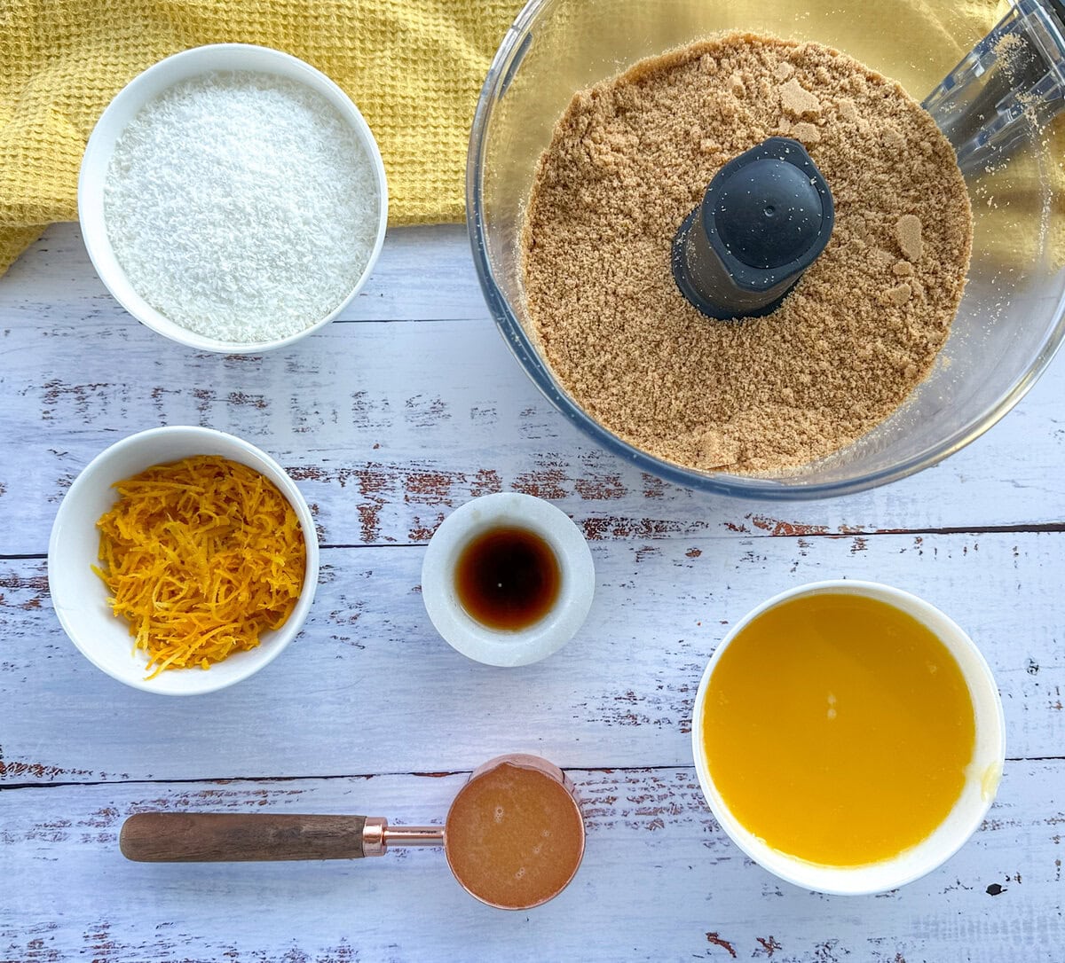 Ingredients for Lemon and coconut Truffles crushed biscuits, melted condensed milk and butter, fresh lemon zest and juice, coconut and vanilla essence