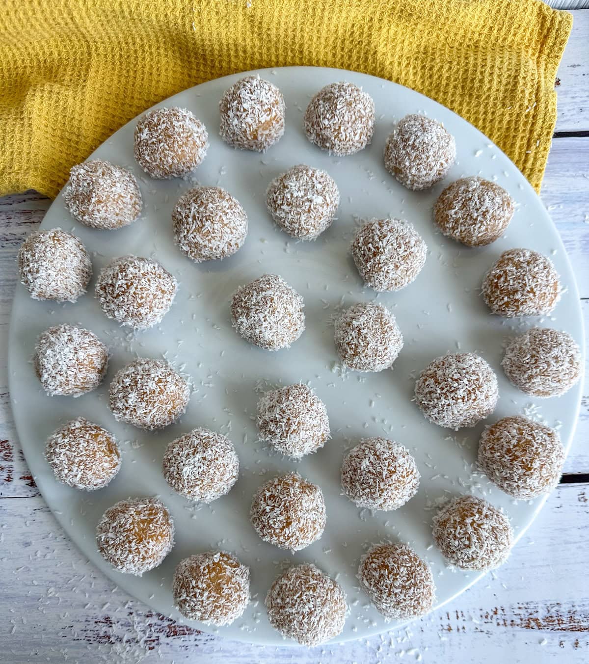 Rolled truffles in coconut ready to chill in the refrigerator