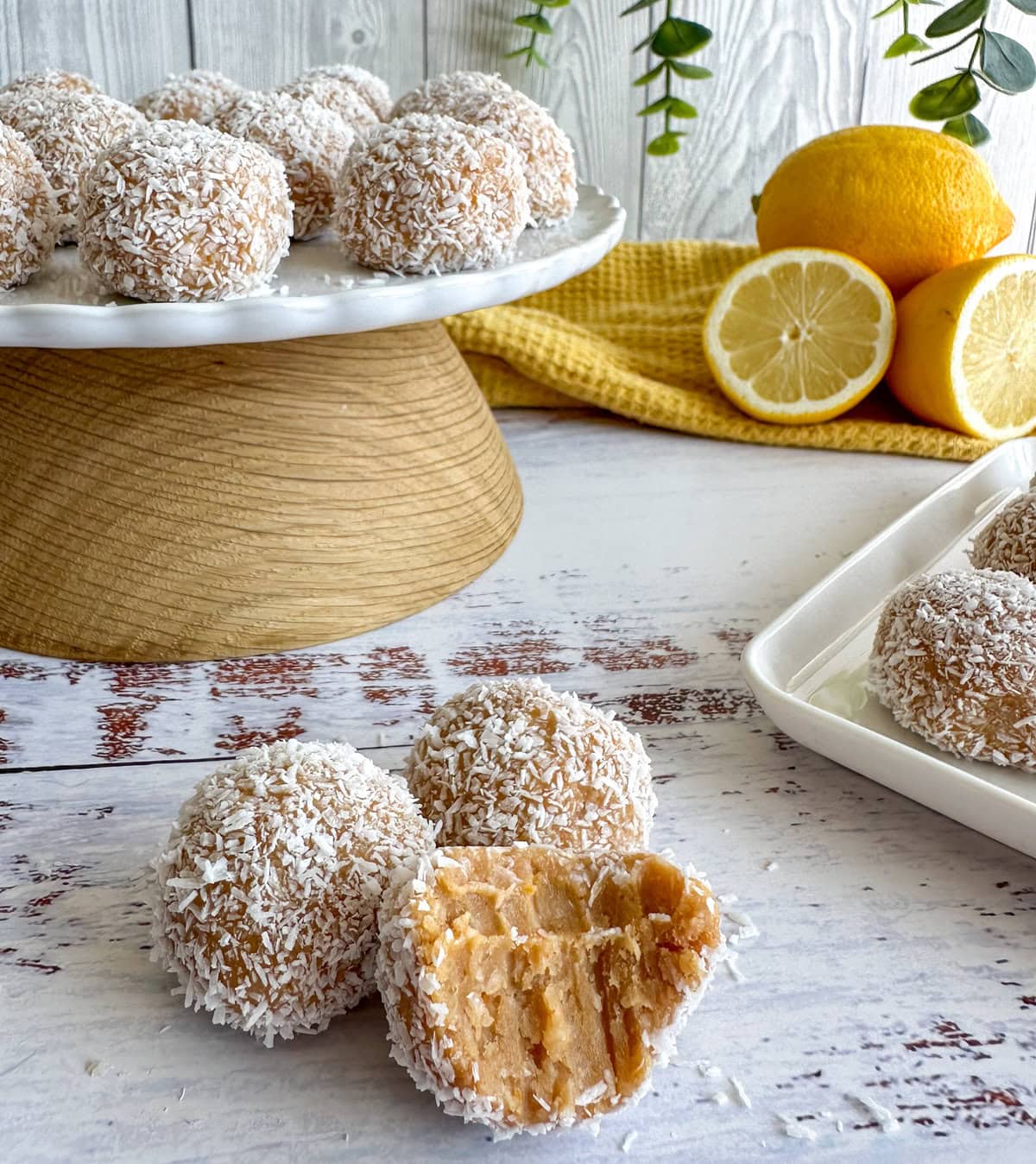 Lemon and Coconut Truffles, made with biscuits, condensed milk and fresh lemons. Sweet treat, balls rolled in coconut with a bite taken out.