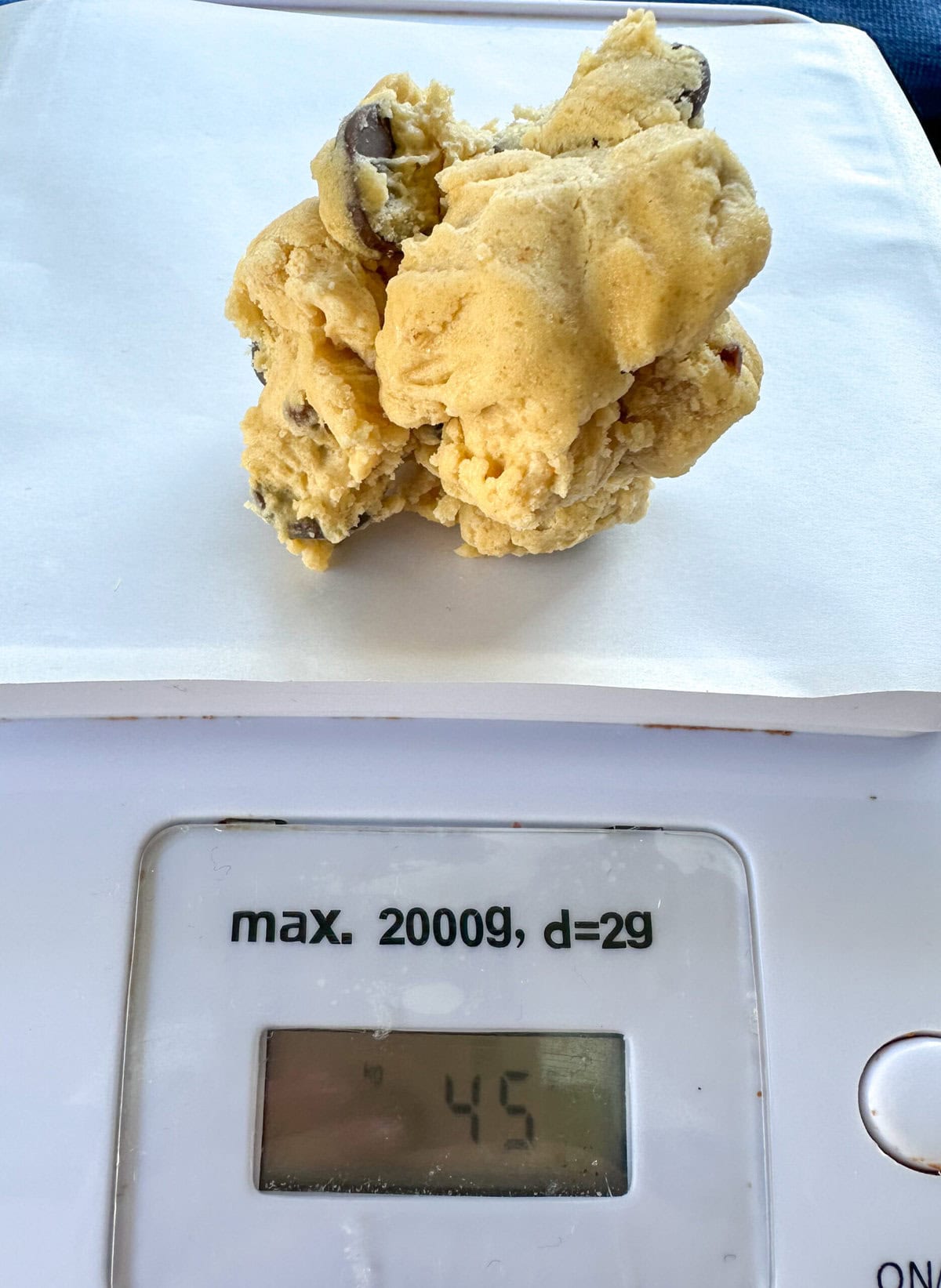 measuring scales with a ball of cookie dough that weighs 45 grams