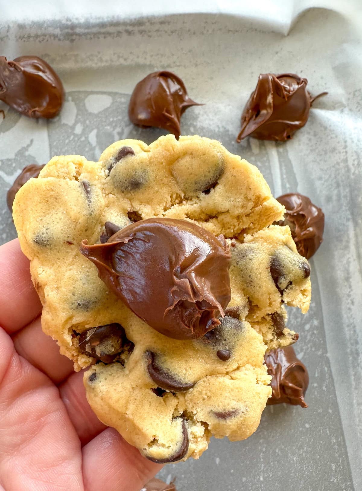 How to stuff cookies with Nutella, place a frozen blob of Nutella inside raw cookie dough