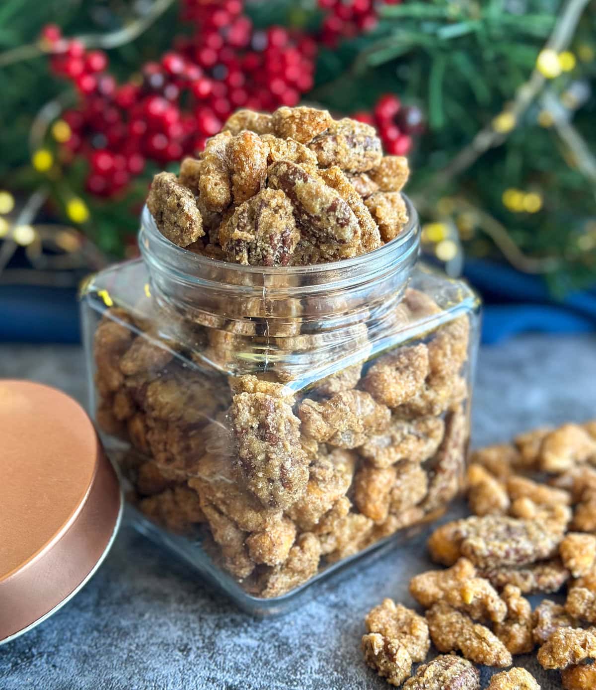 Jar filled with crunchy sweet candied nuts with a festive background