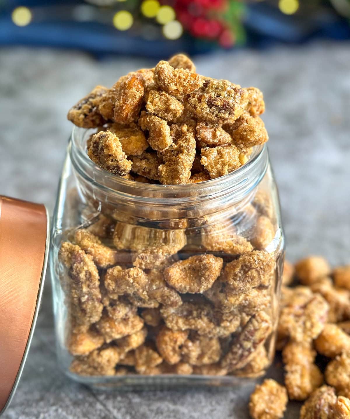 Glass jar holding candied nuts, perfect for gifting