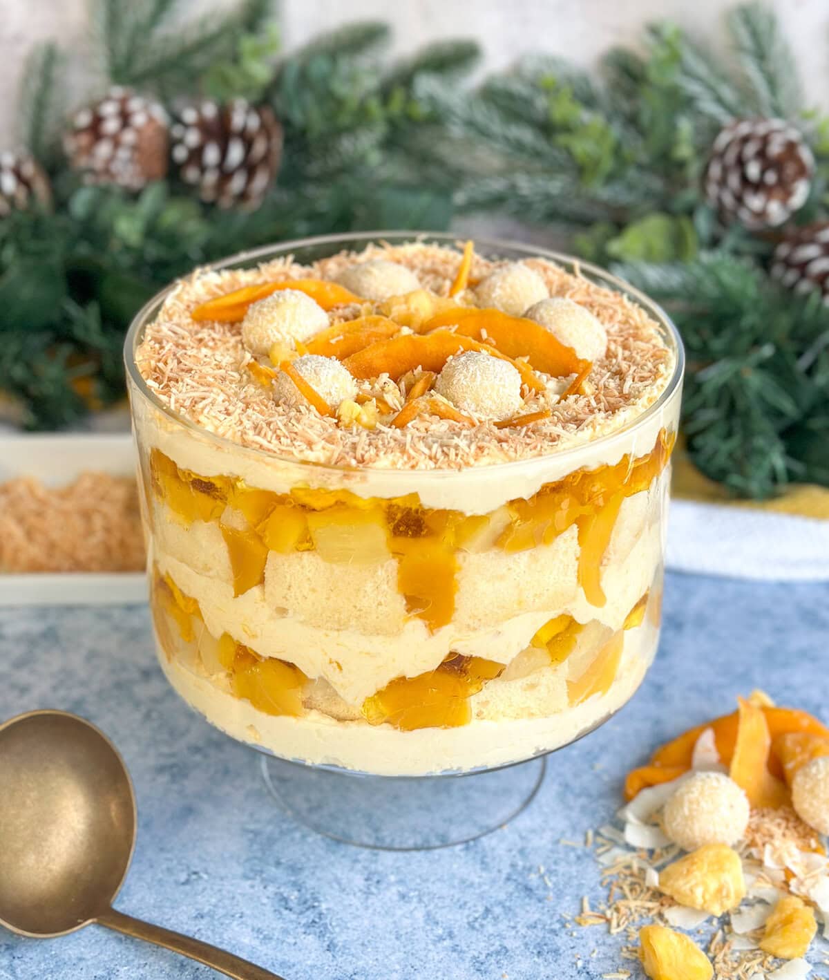 Tropical Coconut Trifle with mango, pineapple and peaches in a large glass trifle bowl