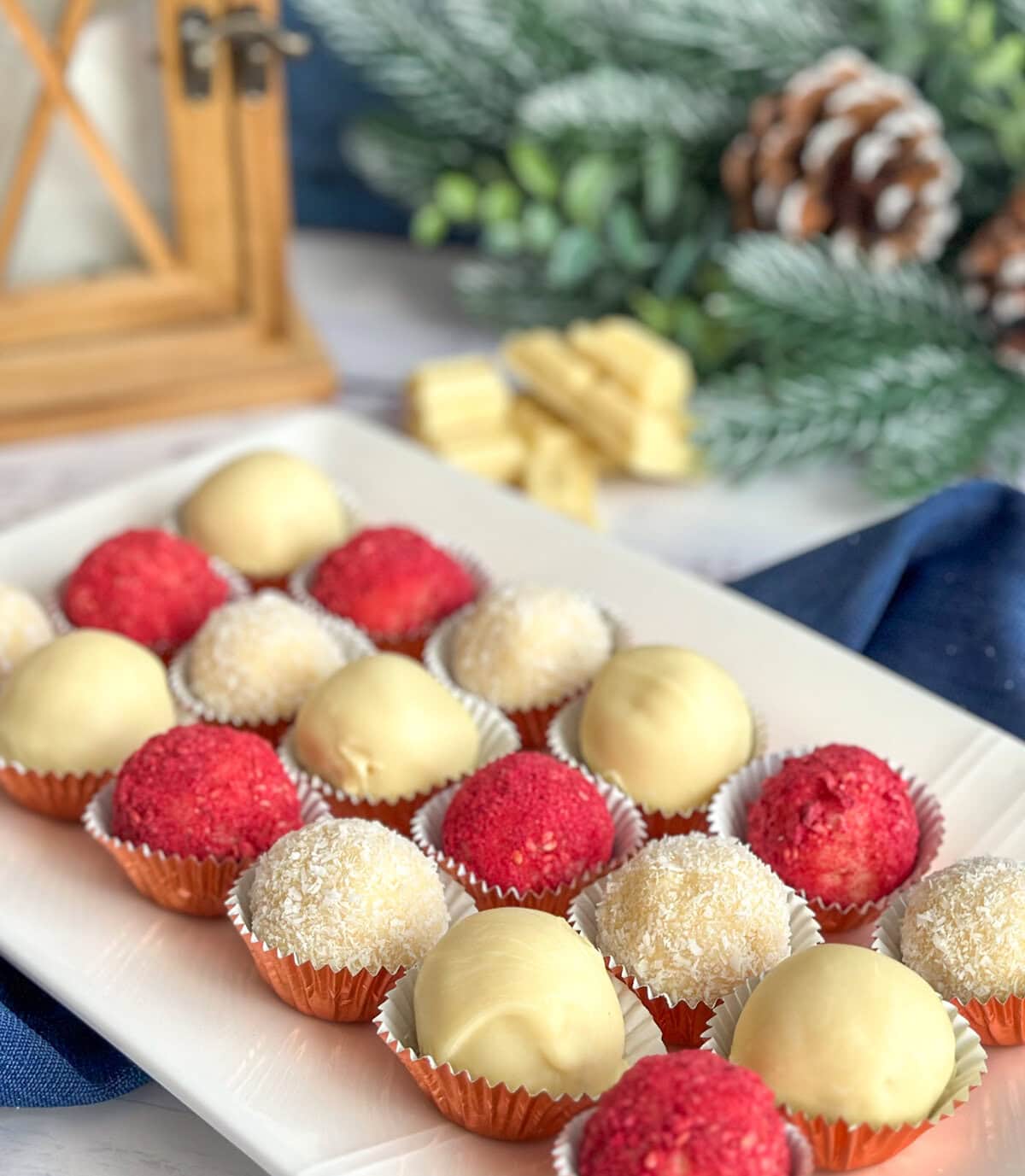 Assortment of white chocolate wafer truffles on a white platter