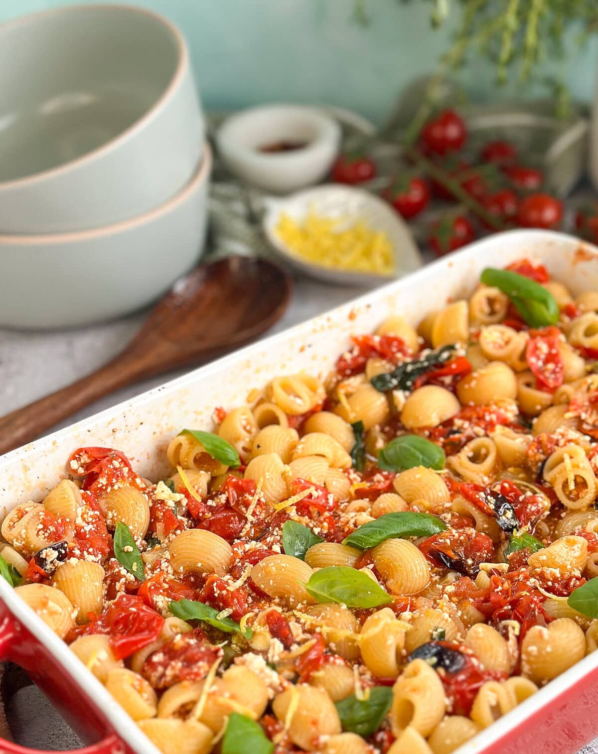 Baked Feta Pasta with cherry tomatoes, garnished with basil and fresh lemon zest