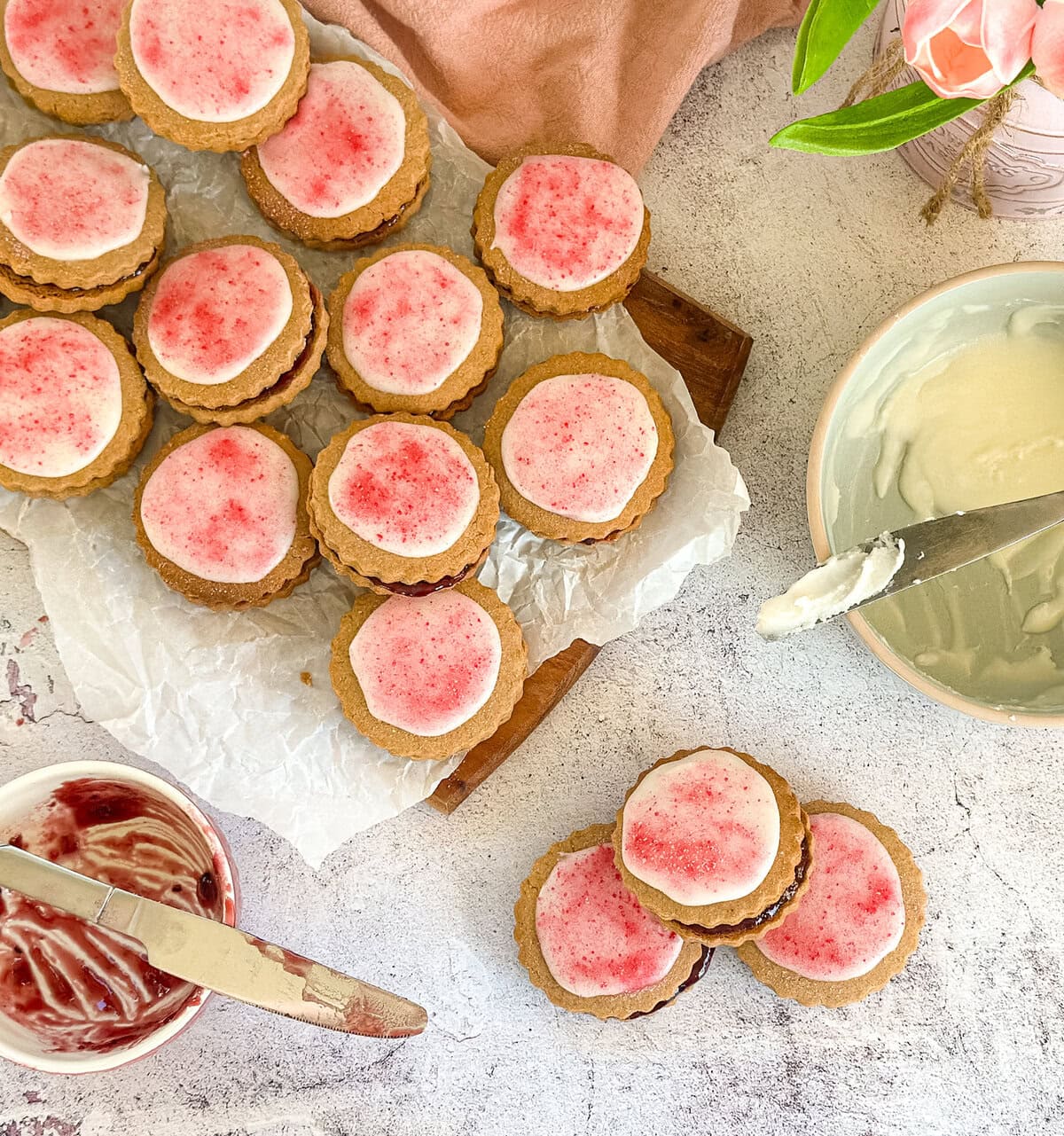 Bowl of icing and jam ready to make Belgium biscuits 