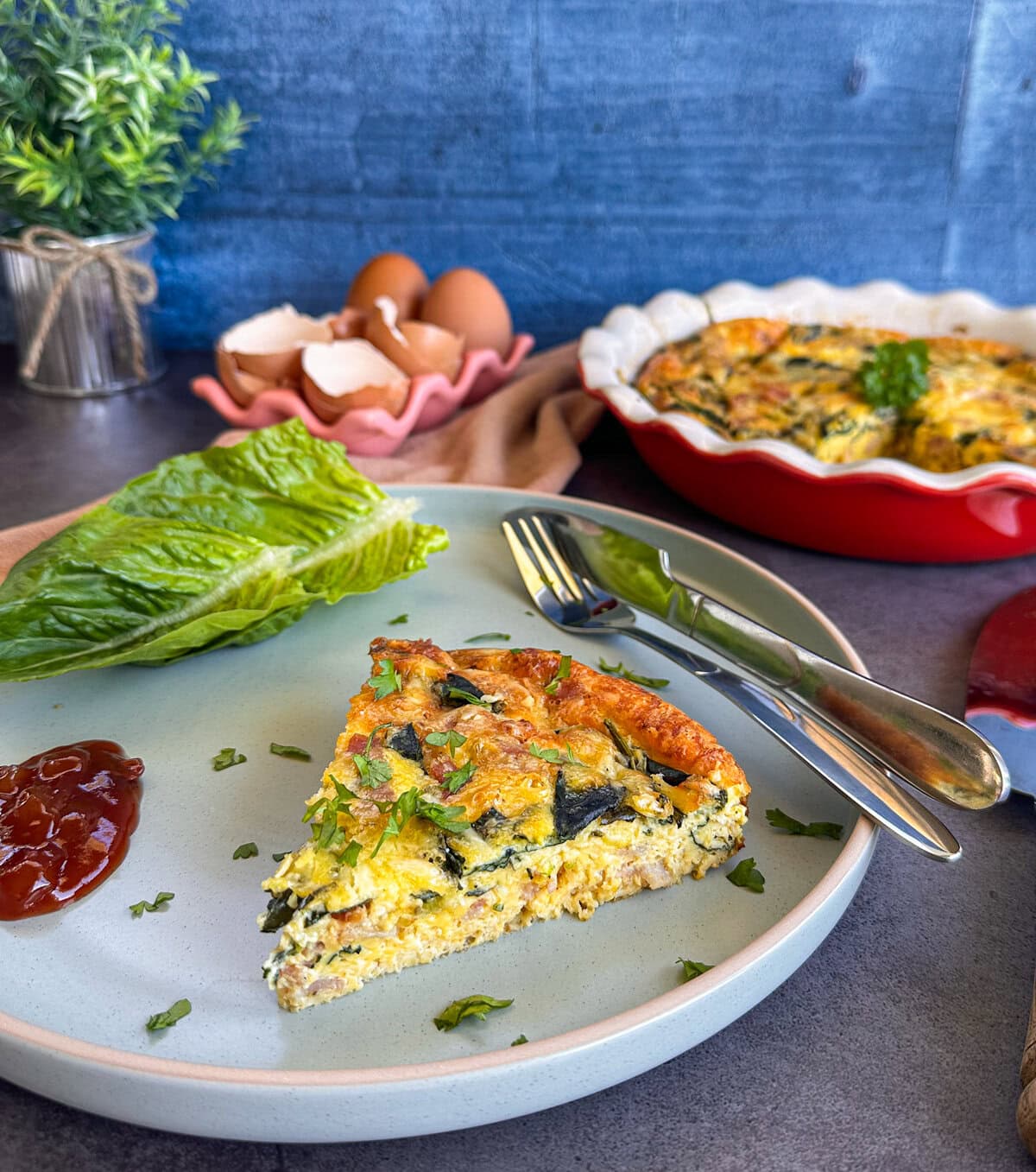 Slice of Crustless Quiche on a plate with chutney and lettuce