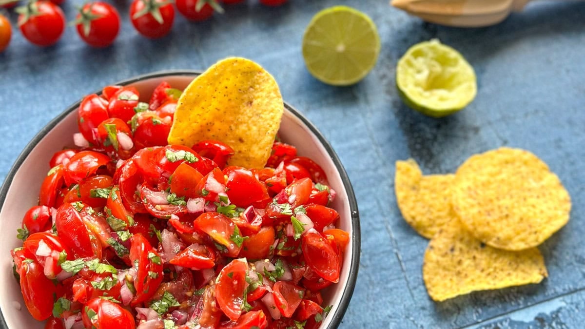 A bowl of fresh salsa and round corn chips