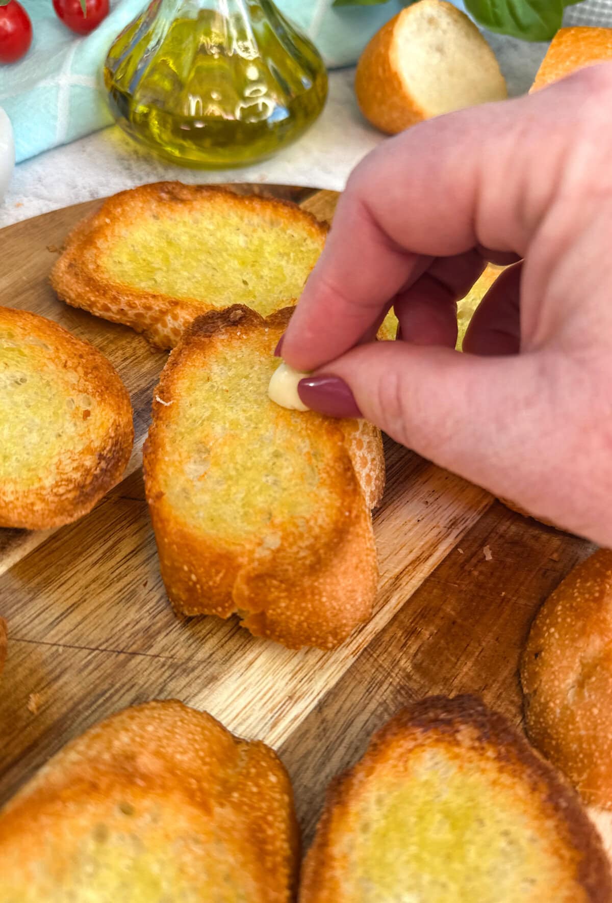 Rub half a clove of raw garlic on top of the bruschetta.