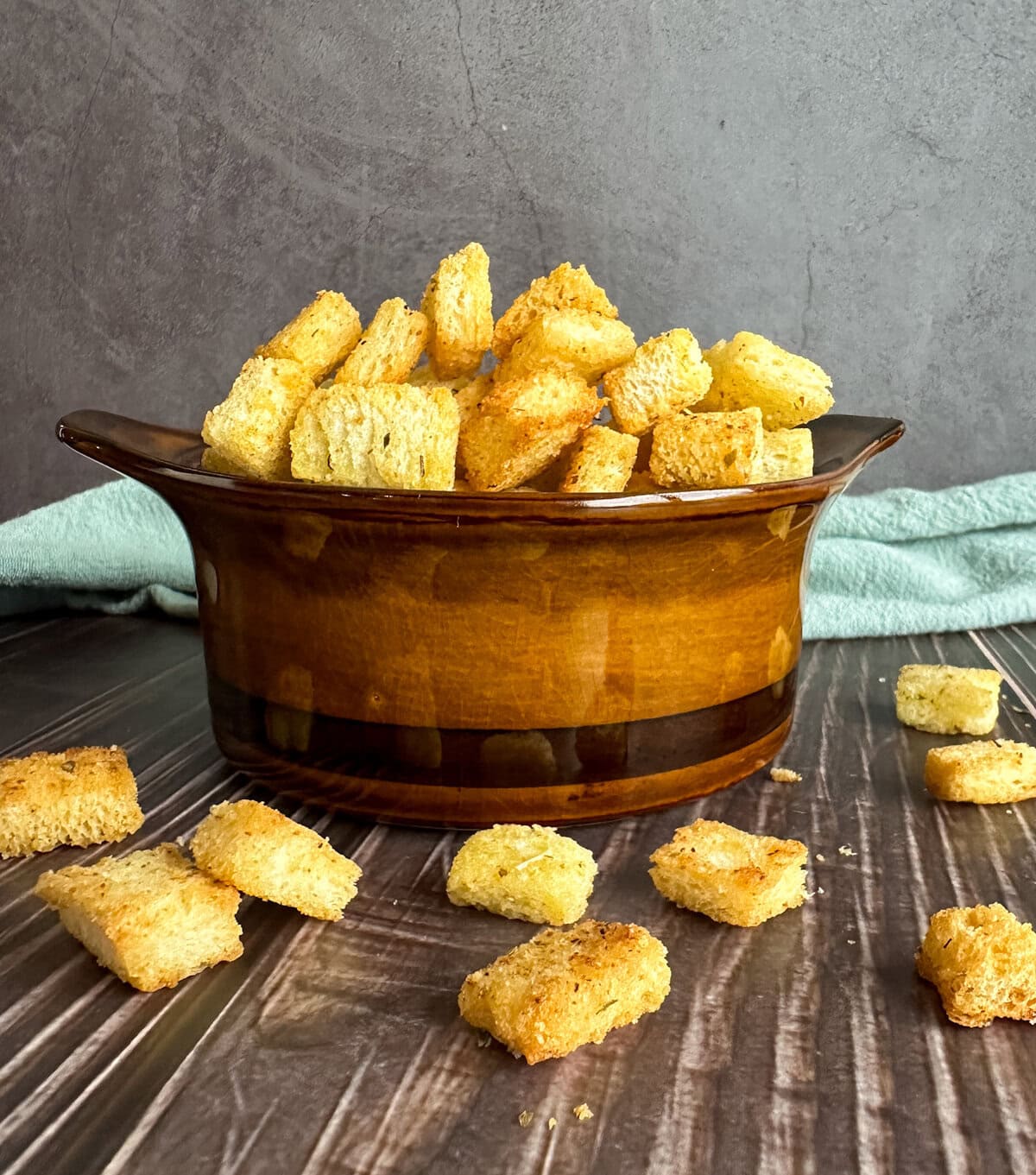 Golden crispy croutons coated in oil, herbs and garlic powder