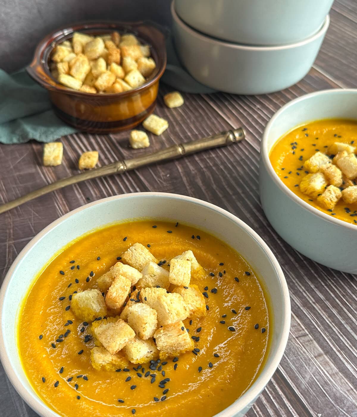 golden crispy croutons on a carrot cumin soup