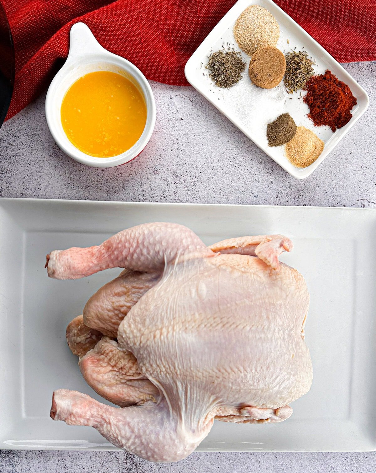 Raw whole chicken spices and butter ready to make a recipe
