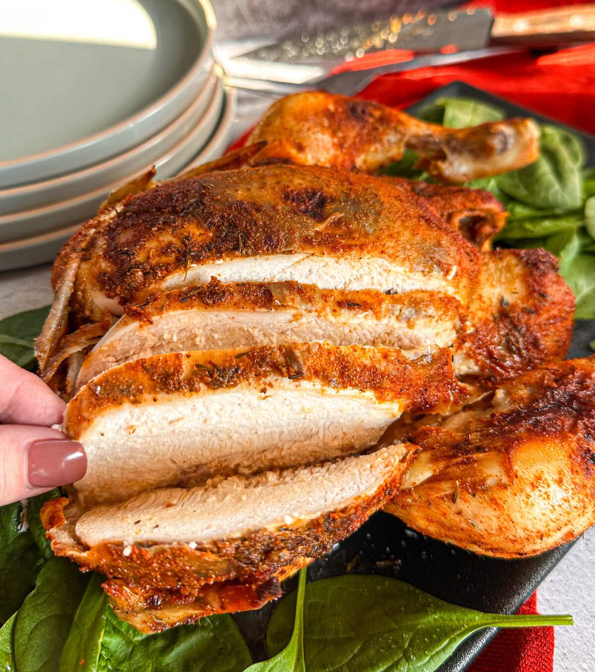 whole roasted chicken with the breast sliced to reveal the white meat