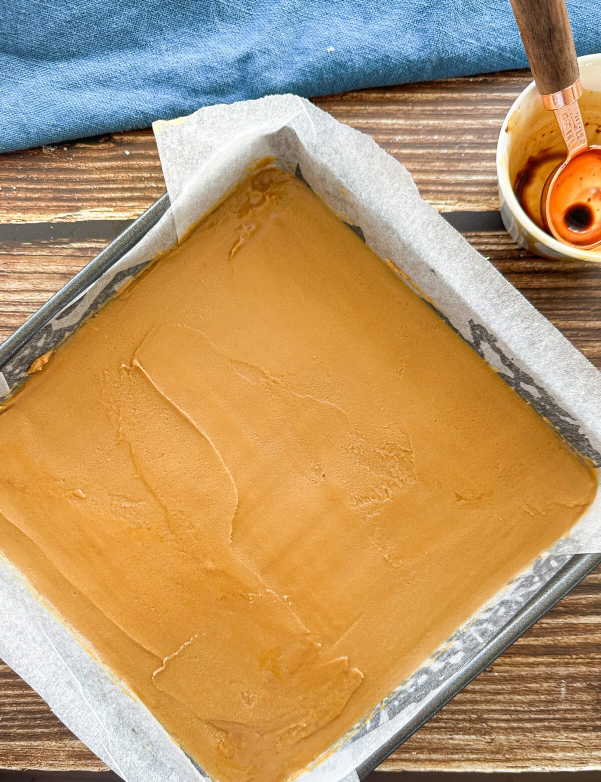 Smoothly spread topping on a coffee and walnut slice