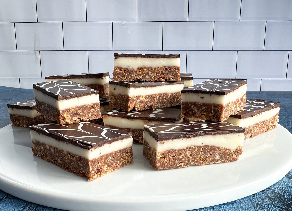 Pieces of no-bake peppermint slice on a white platter