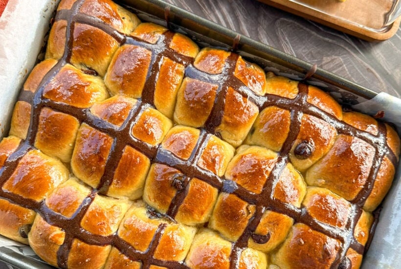 fresh from the oven orange and chocolate hot cross buns with a orange glaze
