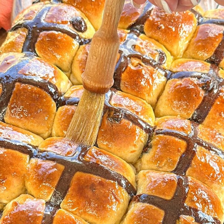 glazing orange chocolate hot cross buns with a sticky orange glaze