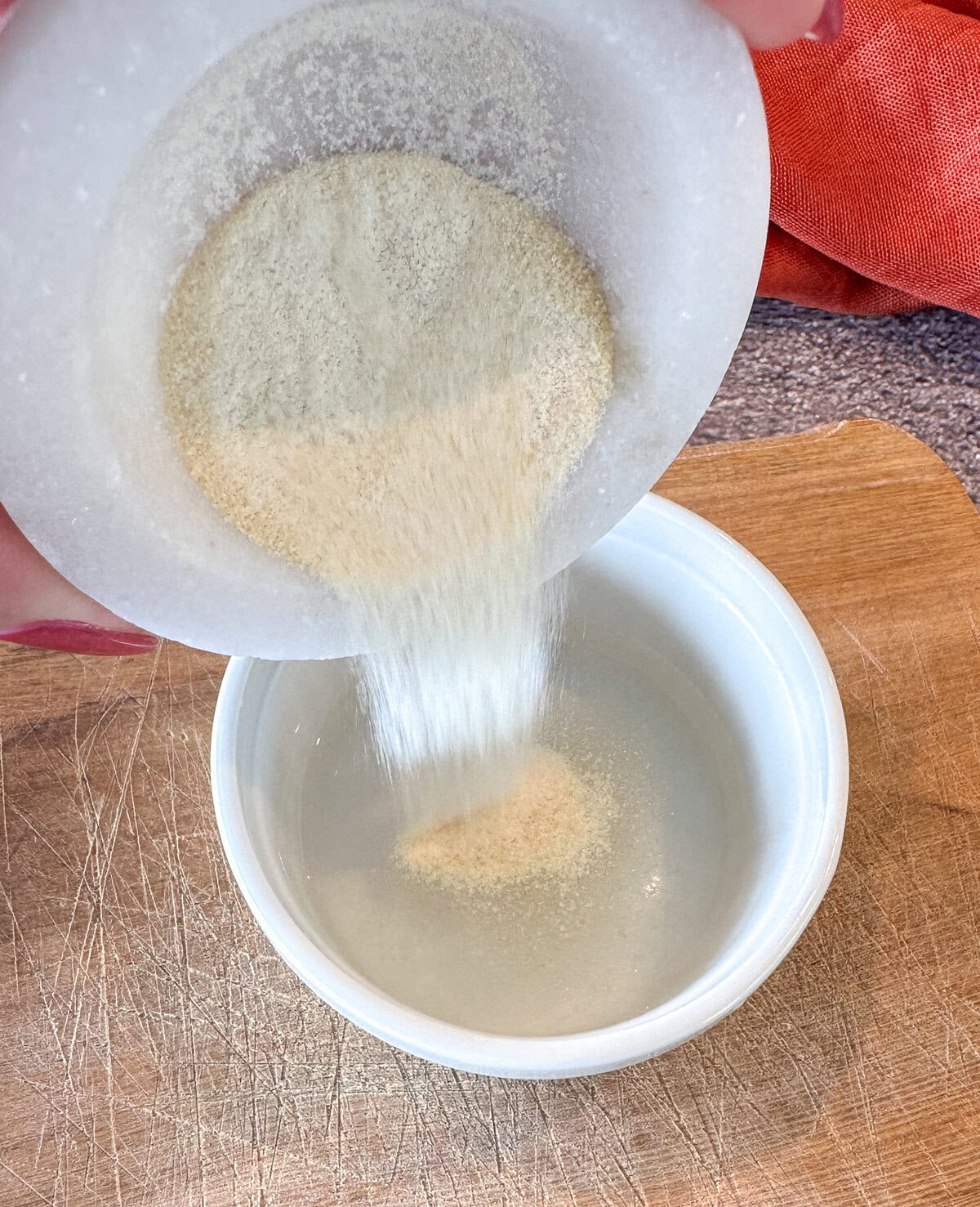 adding gelatin powder to water