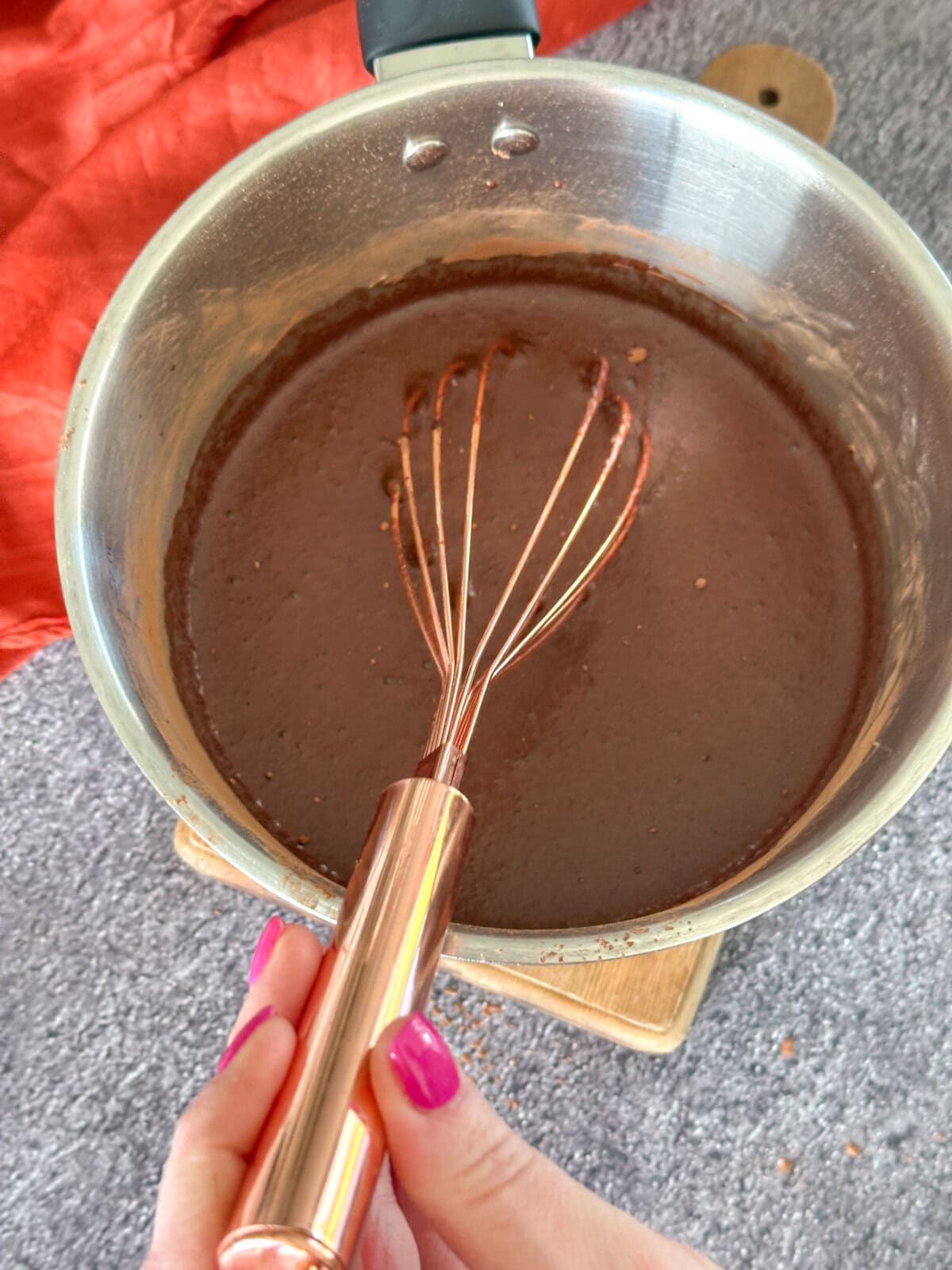 whisking together the chocolate syrup in a saucepan