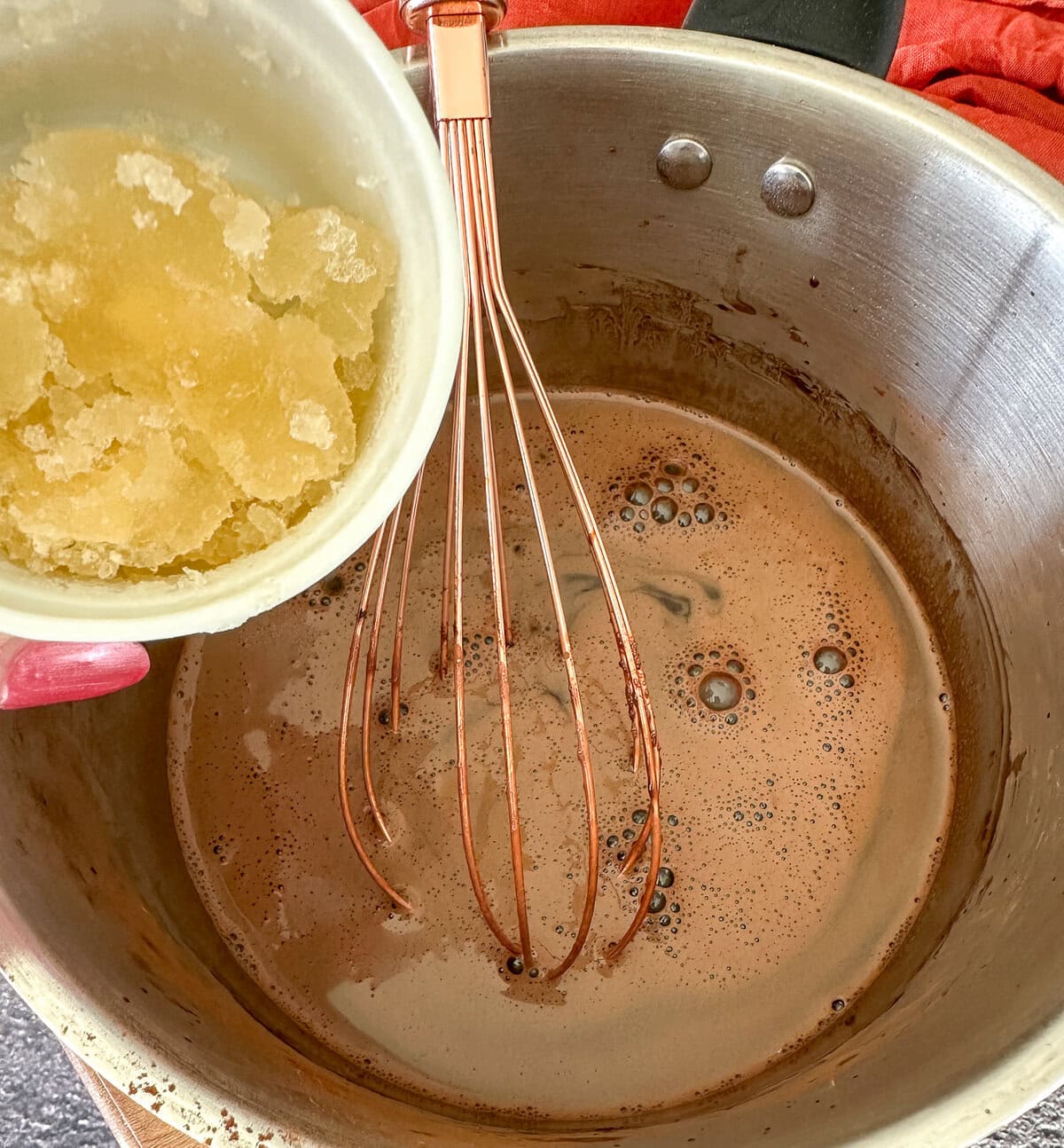 adding bloomed gelatin to the chocolate syrup