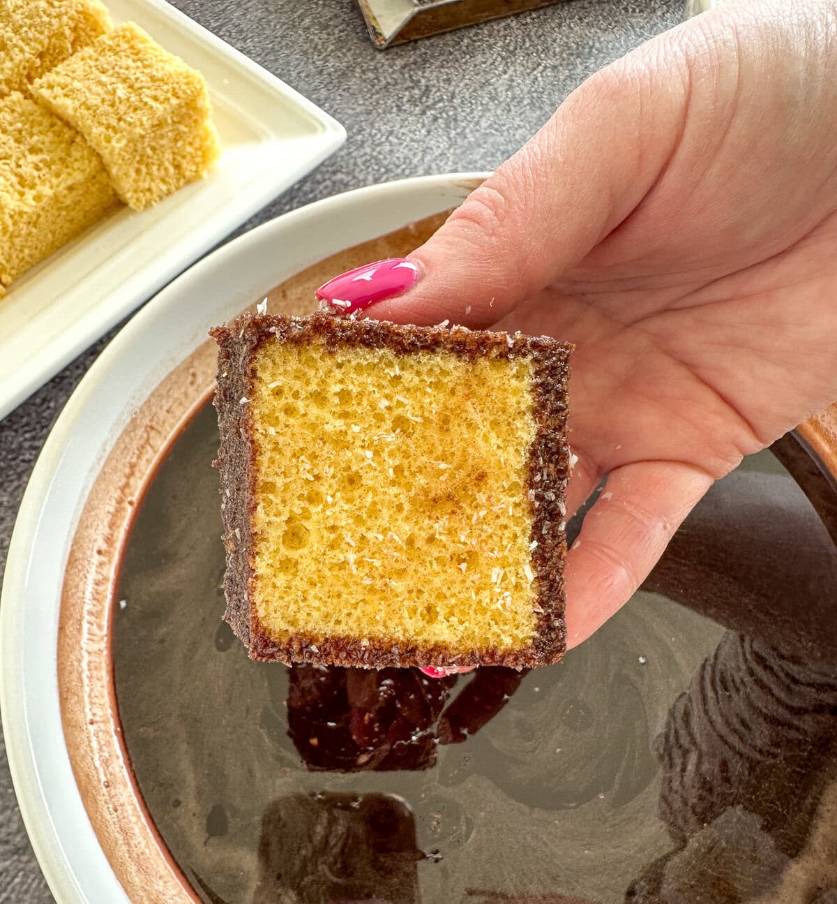 showing a cross section of how much syrup gets into the lamington while dipping
