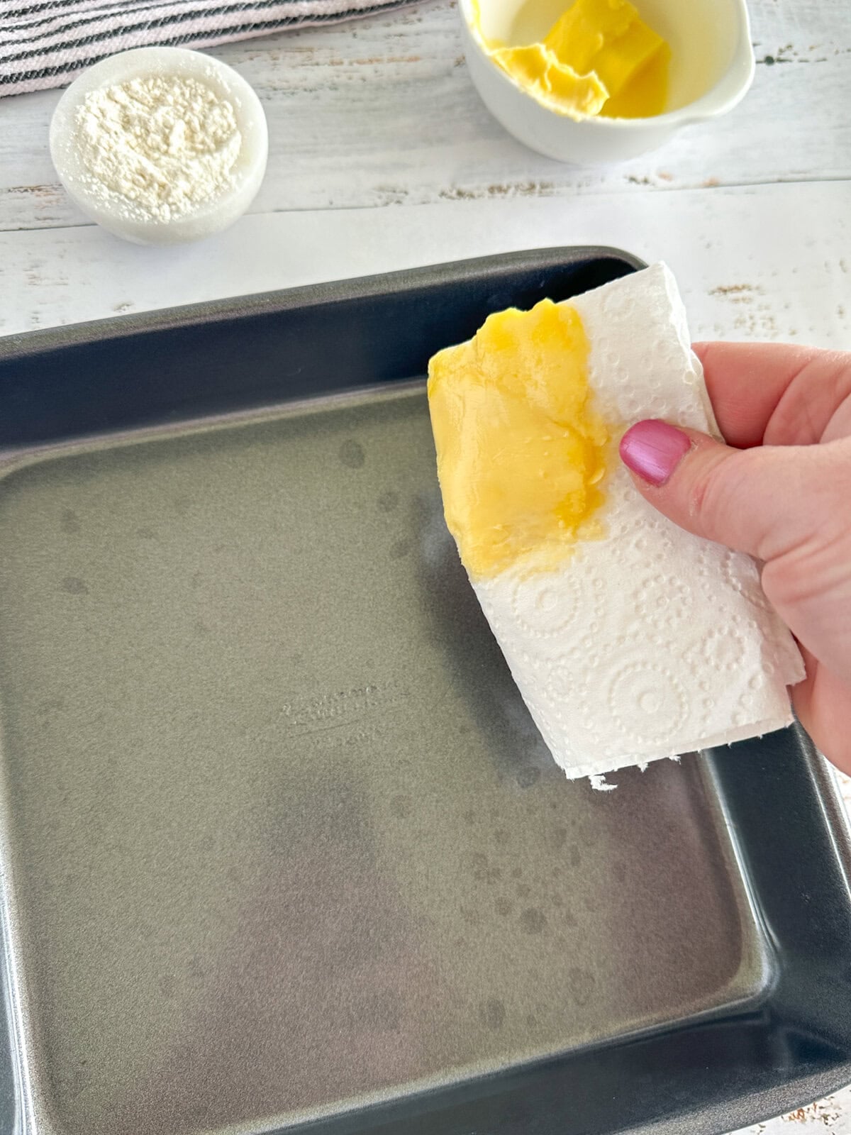 buttering a tin with paper towel