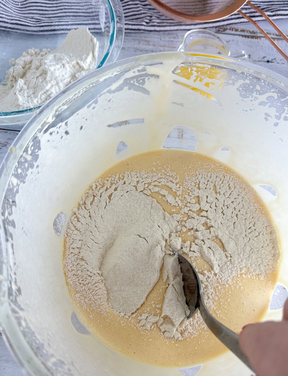 cutting and folding gluten free flour and baking powder into the sponge batter