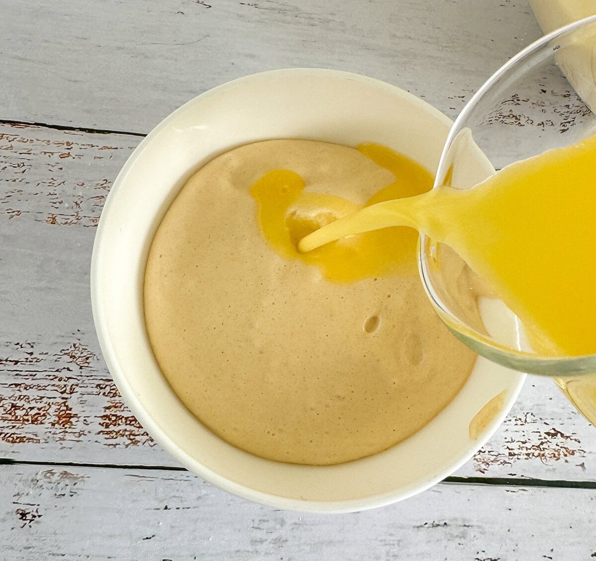 combining a little sponge batter with butter and water