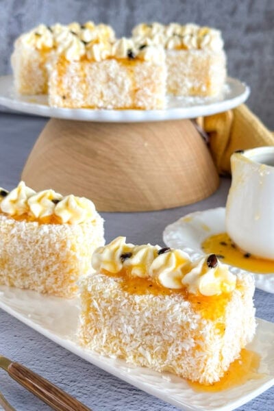 Servings of passionfruit lamingtons with piped mascarpone cream.