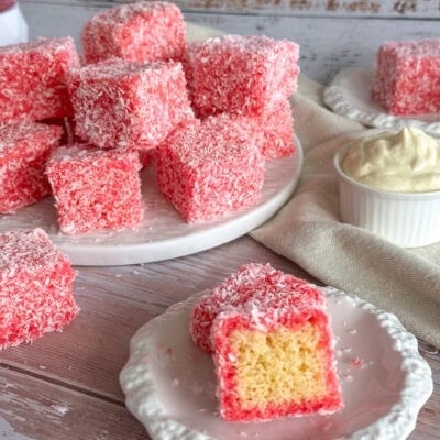 raspberry lamingtons on a white plate and cut in half