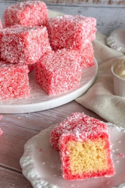 raspberry lamingtons on a white plate and cut in half