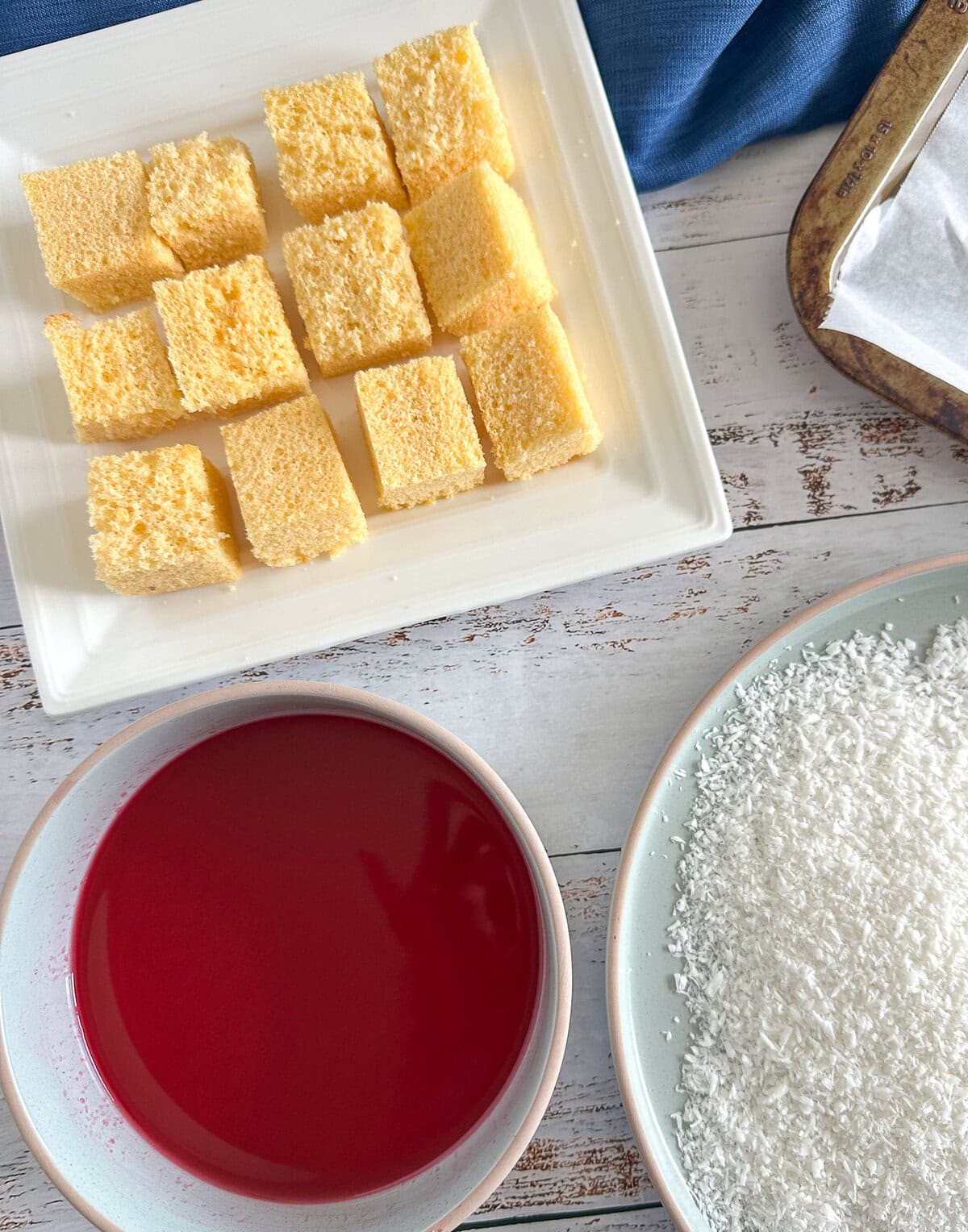 preparing raspberry jelly lamingtons with fresh homemade sponge
